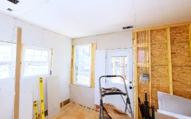 Room addition construction showing electrical wiring and drywall installation in a Dallas home
