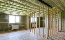 Interior framing and insulation work in progress for a residential room addition in Dallas TX
