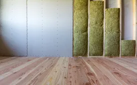 Close-up of insulated stud walls prepared for drywall in a Dallas room addition project