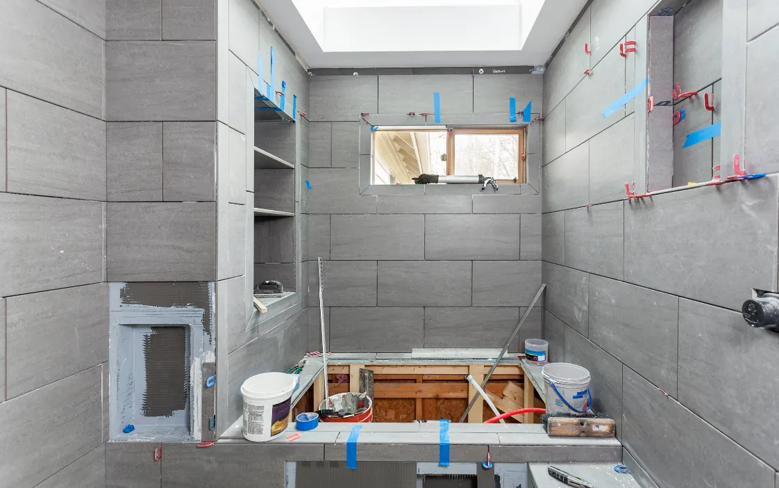 Finished bathroom addition with modern tile, bathtub, and shower in a Dallas home