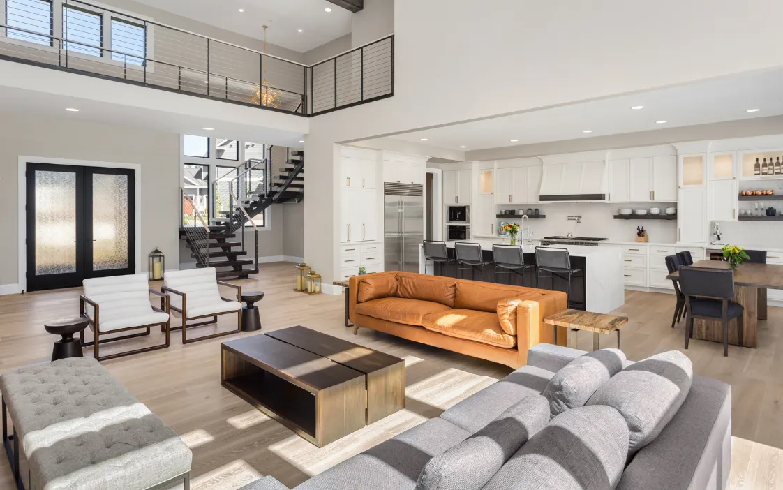 Luxury great room addition in Dallas with high ceilings, modern staircase, open kitchen, and spacious family living area.