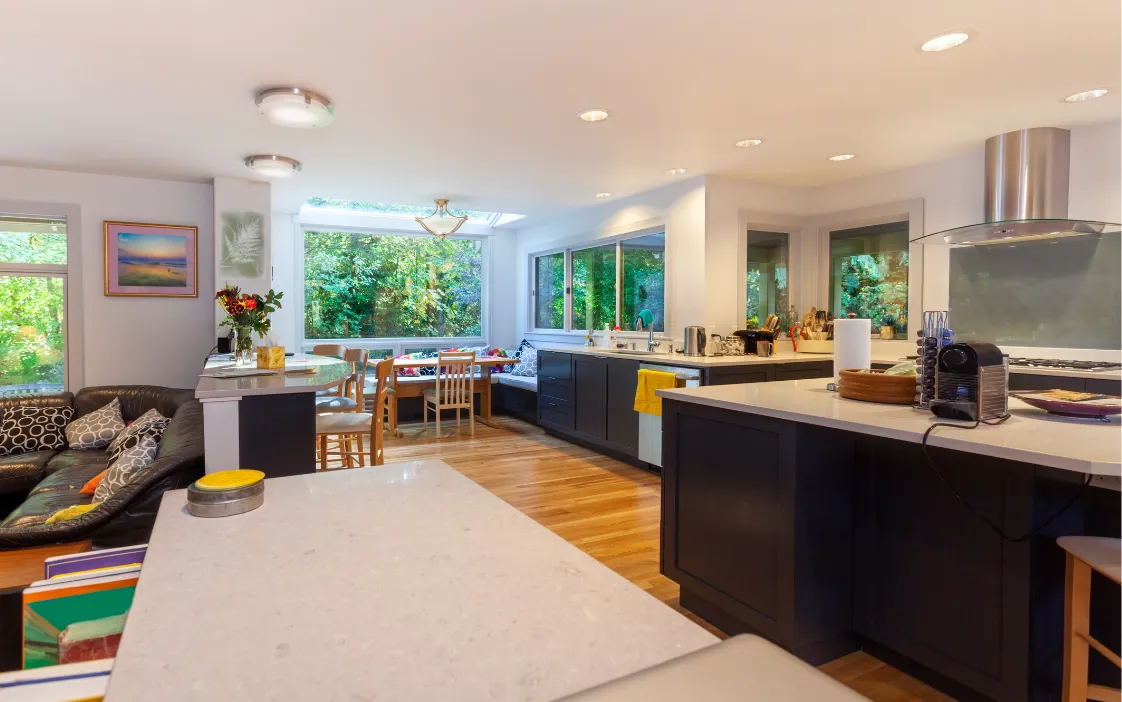 Modern kitchen extension featuring large island, custom cabinetry, and dining space in Dallas TX
