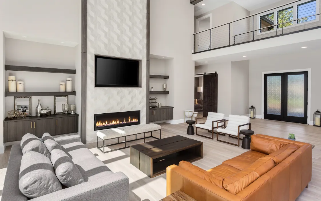 Modern family room addition in Dallas showcasing a custom fireplace feature wall, built-in shelving, and expansive great room layout.